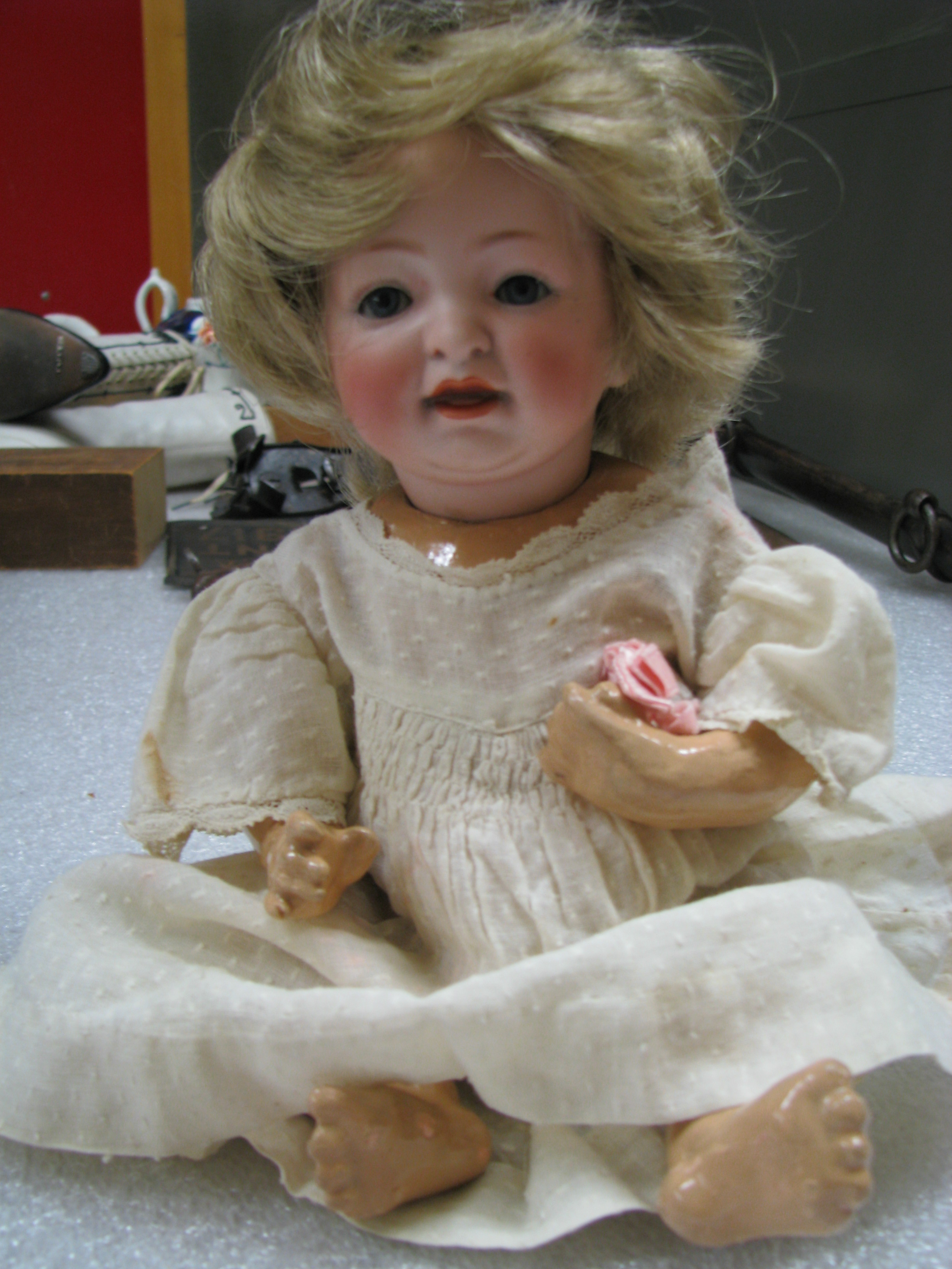 a%20plastic%20doll%20with%20blond%20her%20wearing%20a%20white%20nightgown